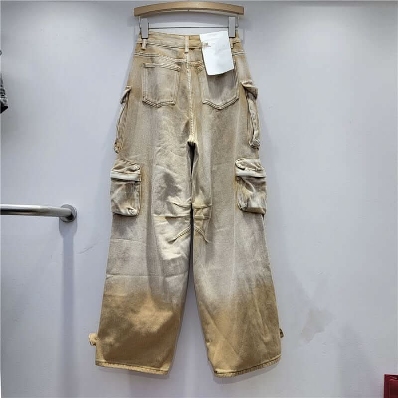 Desert Storm Cargo Pants with multi-pocket design and washed vintage finish on a hanger, showcasing rugged streetwear style.