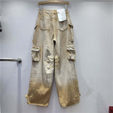 Desert Storm Cargo Pants with multi-pocket design and washed vintage finish on a hanger, showcasing rugged streetwear style.
