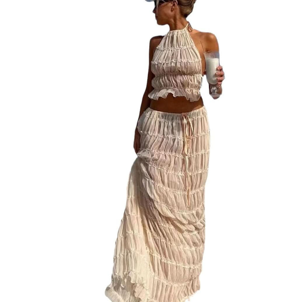 Woman wearing Isla Breeze Two-Piece Set with crinkle fabric crop top and maxi skirt, perfect for beach strolls and summer elegance.