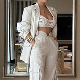 Woman wearing chic linen-blend two-piece set with blazer and high-waisted cargo pants, perfect for day or night elegance.
