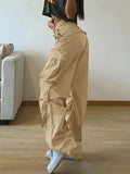 Beige Gravity Parachute Pants with exaggerated volume and adjustable toggles, showcasing a bold streetwear vibe for fashion-forward girls.