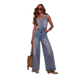 Woman in Denim Dream Jumpsuit with V-neck and wide-leg style, accessorized with sunglasses and handbag, showcasing retro-inspired fashion.