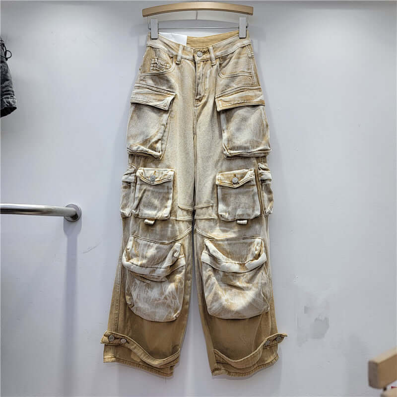 Desert Storm Cargo Pants with multi-pocket design in washed vintage finish hanging on a rack, ideal for edgy streetwear fashion.