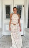 Woman wearing Isla Breeze Two-Piece Set with high-neck crop top and flowy maxi skirt in textured crinkle fabric.