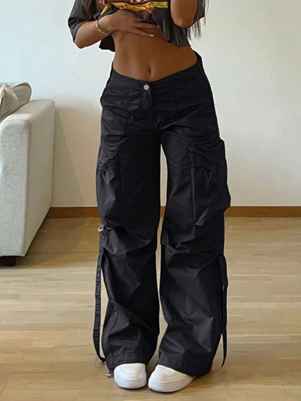 Black Gravity Parachute Pants with adjustable toggles and cargo-style pockets, showcasing bold streetwear fashion.