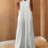 Coastal Flow Jumpsuit with V-neckline, spaghetti straps, and hidden pockets, perfect for summer beach getaways and casual outings.