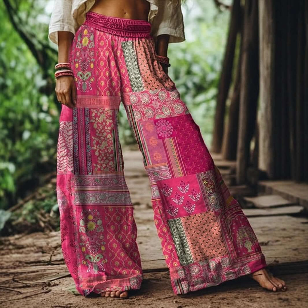 Woman wearing Boho Bloom Pants with floral embroidery and wide-leg fit, ideal for bohemian style, summer outings, and sunset markets.